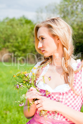 young woman with pink dirndl outdoor