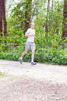 man is jogging in the forest