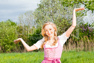 young woman with pink dirndl outdoor