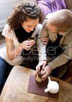Couple is drinking tea in the living room.