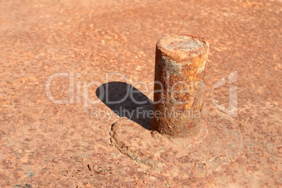 Rusty pipe welded to platform