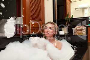 Pretty woman laying in bath