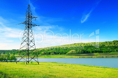 High-voltage power line on the shore of the lake.