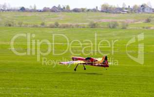 RC model airplane lands on the grass