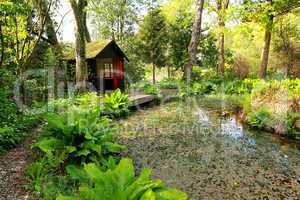 Beautiful romantic garden with a pond in Springtime