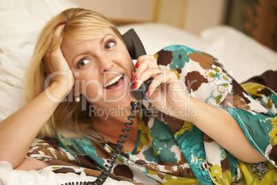 Woman Laying on Her Bed Using the Telephone