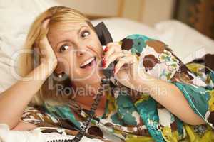 Woman Laying on Her Bed Using the Telephone
