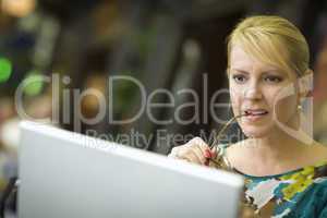 Beautiful Blonde Woman On Her Cell Phone and Laptop Computer in