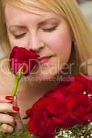 Woman Smelling a Bunch of Red Roses