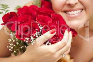 Smiling Woman Holding Bunch of Red Roses