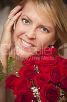 Smiling Blonde Woman with Red Roses