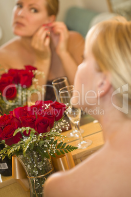 Blonde Woman Applies Makeup at Mirror Near Champagne and Roses