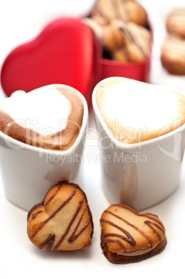 heart shaped cream cookies on red heart metal box and coffee