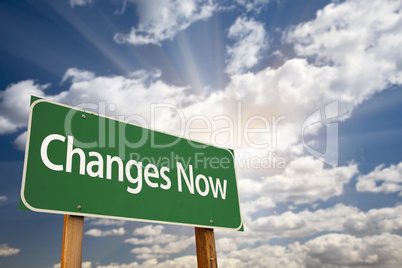 Changes Now Green Road Sign and Clouds