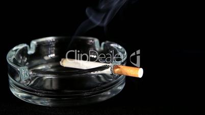 Smoldering Cigarette on the black background