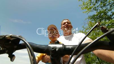 Father With Toddler Riding The Bike