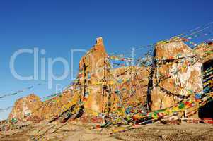 Huge rocks wrapped with colorful prayer flags