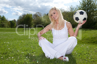 Smiling woman about to throw a football