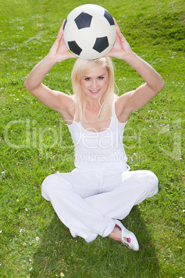 Smiling blonde holding a soccerball