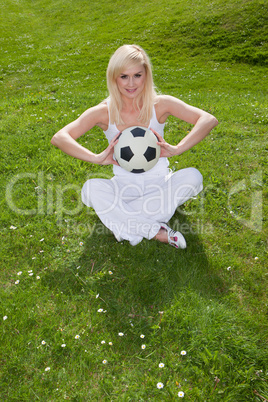 Pretty woman holding a football