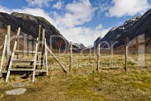 fence with stairs in rural landscape