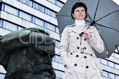 Woman with umbrella in front of Karl Marx monument in Chemnitz