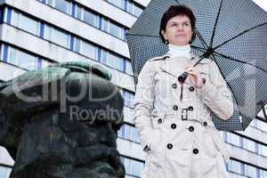 Woman with umbrella in front of Karl Marx monument in Chemnitz