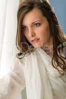 Thoughtful brunette woman looking out of window
