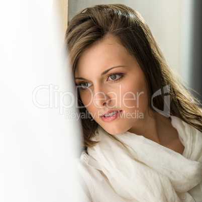 Thoughtful brunette woman looking out of window