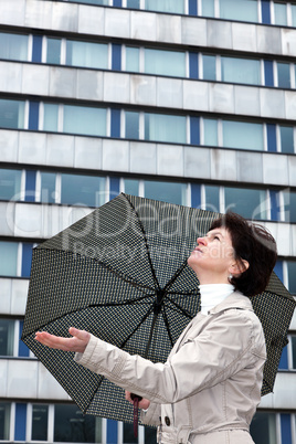 Woman with umbrella check whether it's raining