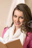 Beautiful young woman student hold book