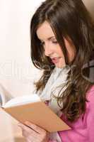 Beautiful young woman student reading book
