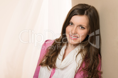 Smiling brunette woman in pink top