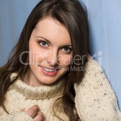 Smiling winter brunette woman in beige sweater