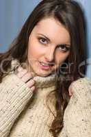 Smiling winter brunette woman in beige sweater