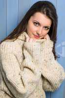 Smiling winter brunette woman in beige sweater