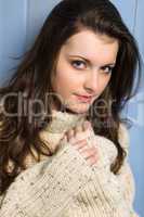 Winter brunette woman in beige sweater