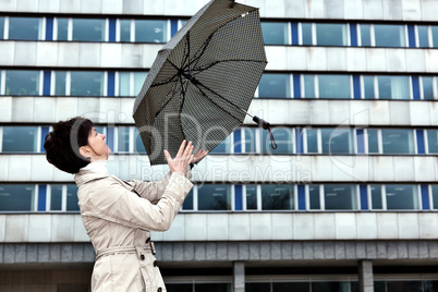 Woman with umbrella in windy weather