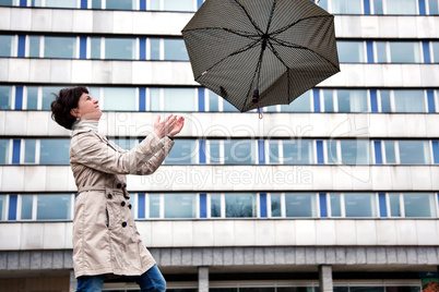 Woman with umbrella in windy weather