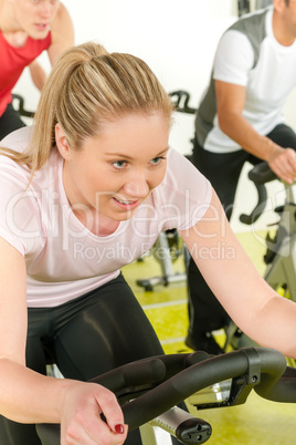 Young woman at bike spinning class