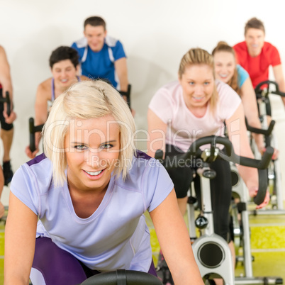 Fitness young woman on gym bike spinning