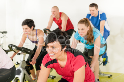 Fitness group of people on gym bike