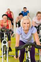 Young woman at spinning class enjoy workout