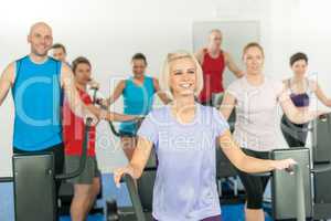 Fitness young group on elliptical cross trainer