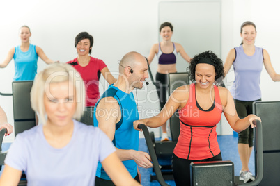 Fitness instructor leading class of alpinning