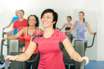 Smiling woman at fitness class gym workout