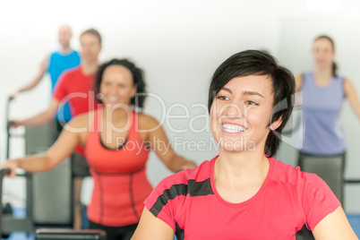 Smiling woman at fitness class gym workout