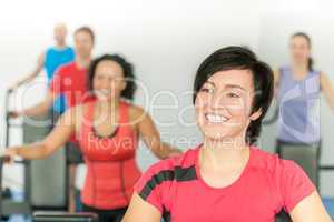 Smiling woman at fitness class gym workout