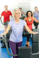 Young fitness woman at treadmill running class
