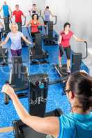 Fitness instructor leading treadmill running class